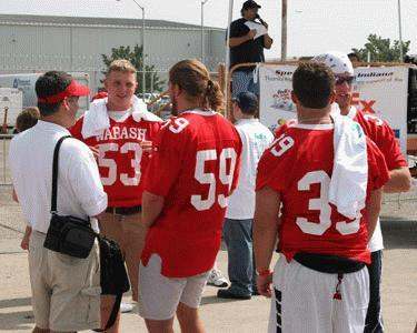 a group of football players talking