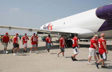 a group of people walking next to a plane