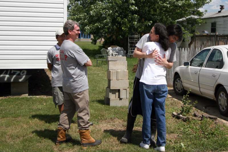 a group of people hugging in a yard