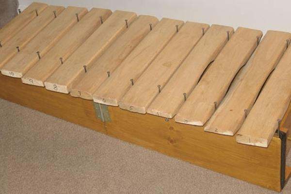 a wooden xylophone with nails