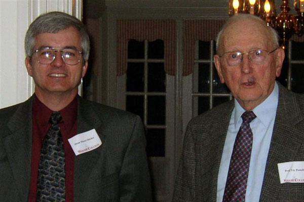 a couple of men wearing suits and ties