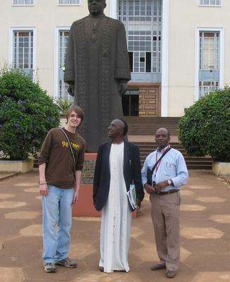 a group of people standing in front of a statue