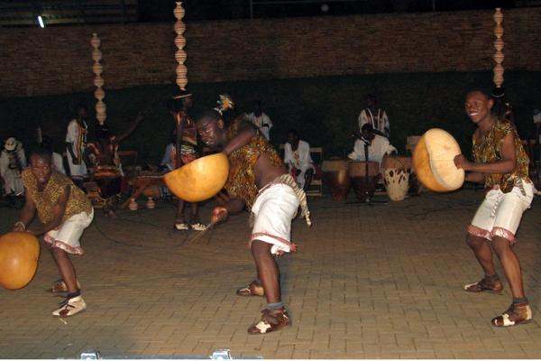 a man playing drums with other people