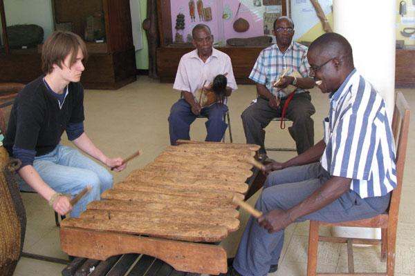 a group of people playing a xylophone