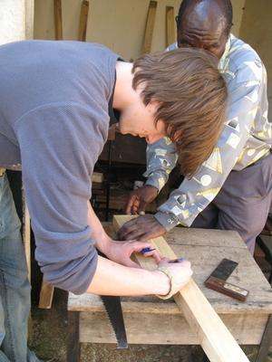 a group of people working on a wood project