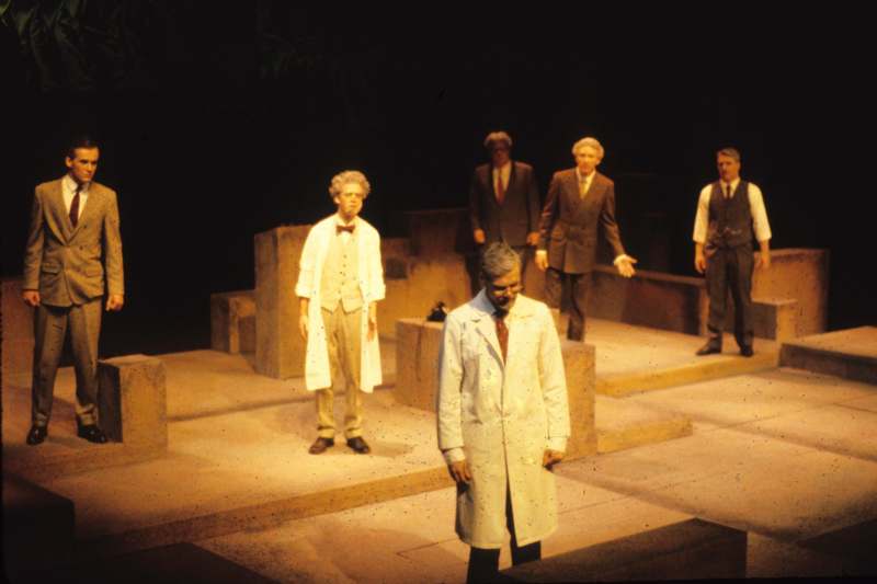 a group of men in suits standing on a stage
