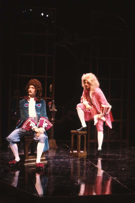 two men in clothing on a stage