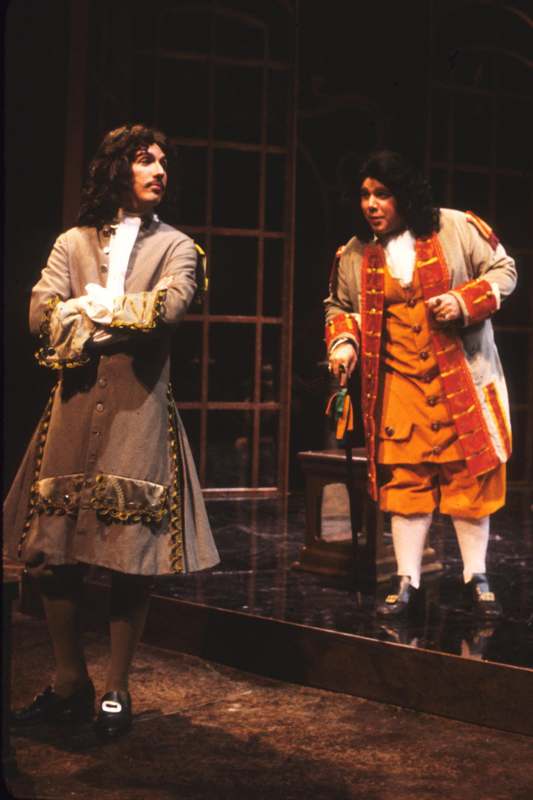 a man in a garment standing next to a man in a garment