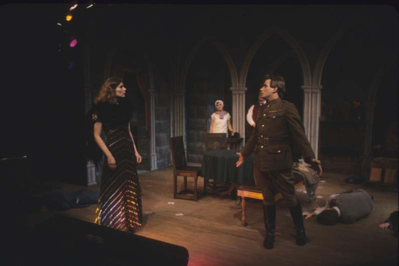 a man in a military uniform and a woman in a dress on a stage