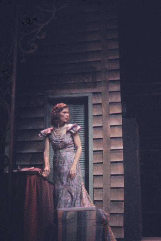 a woman in a dress standing on a stage