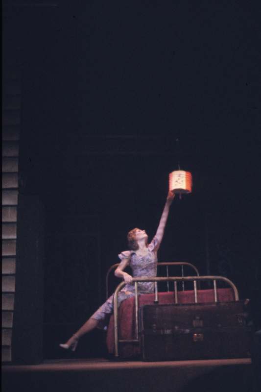 a woman holding a lantern