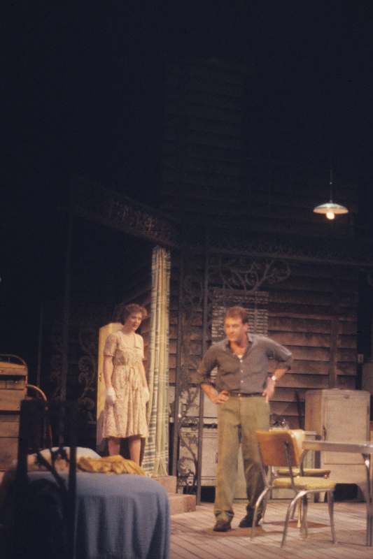 a man and woman standing on a stage