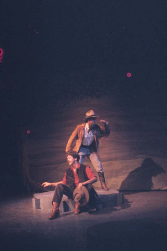 a man in cowboy clothes and a man in cowboy clothes on stage