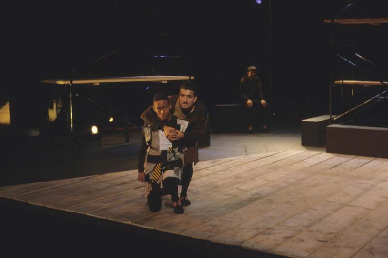 a man holding another man on a stage