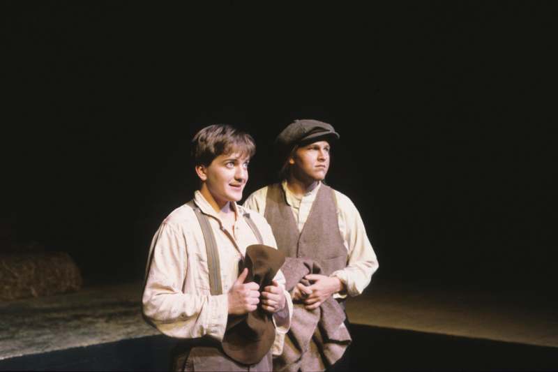 a pair of men standing on a stage