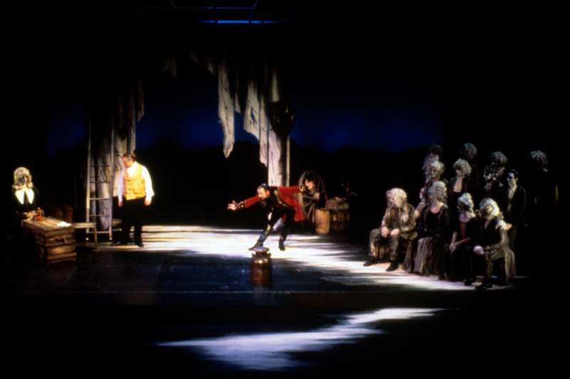 a man in a red garment on a stage