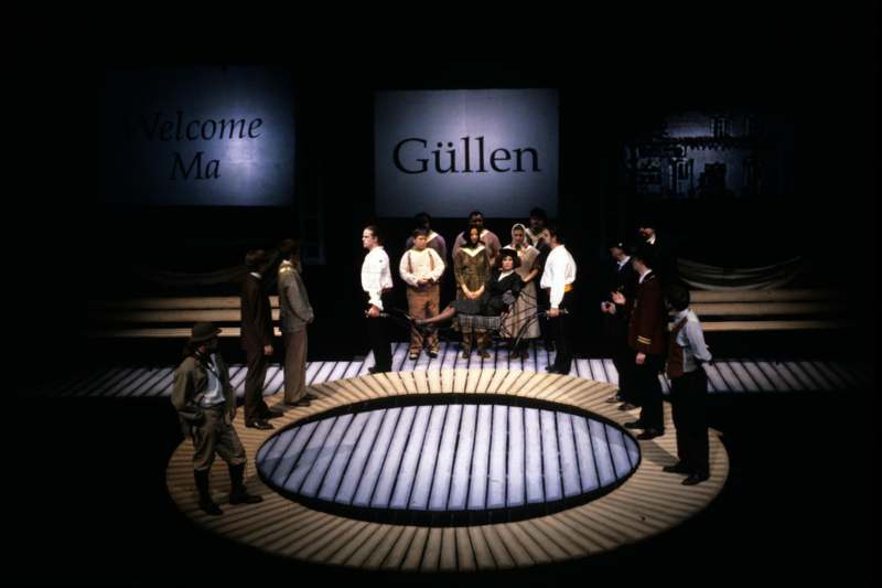 a group of people standing around a circular stage