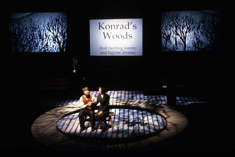 a man and woman sitting on a stage