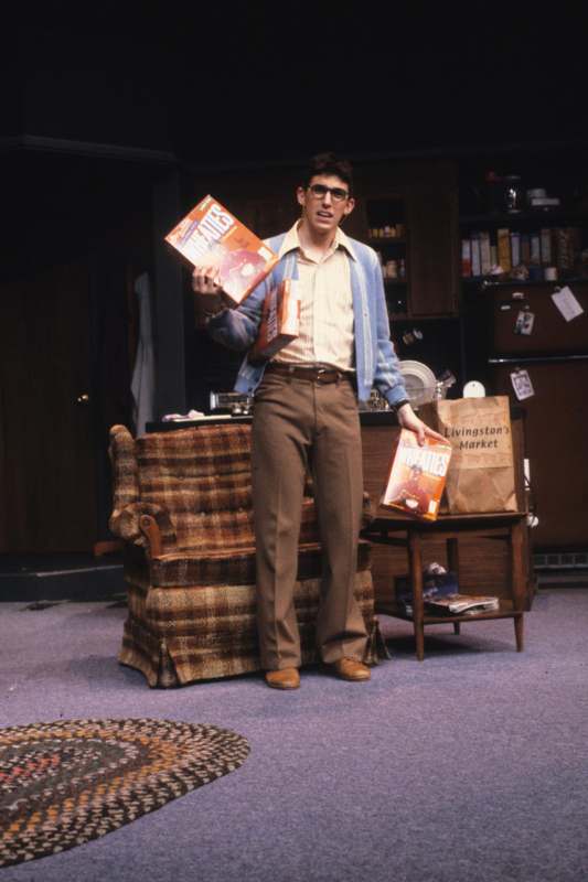 a man holding boxes in a room