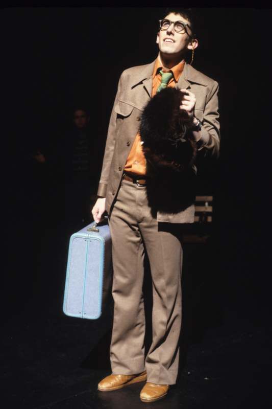 a man in a suit holding a suitcase