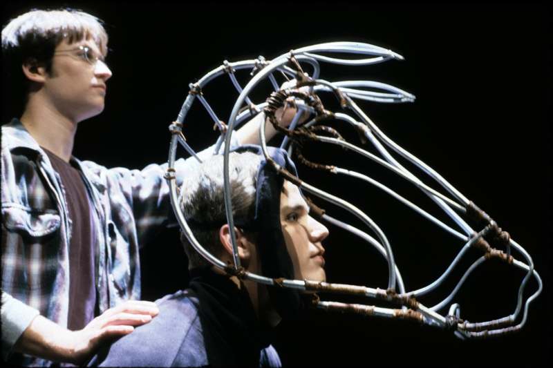 a man with a head piece made of wires