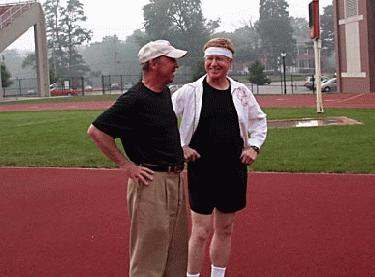 a couple of men standing on a track
