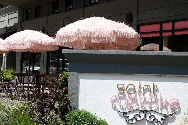 pink umbrellas on top of a wall
