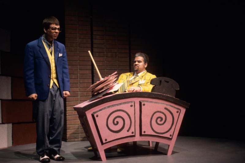 a man standing next to a man on a stage
