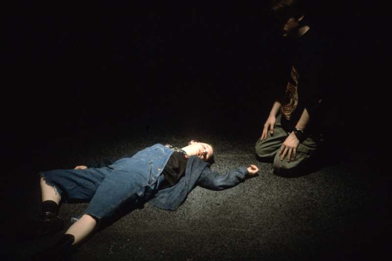 a man lying on the ground next to a man