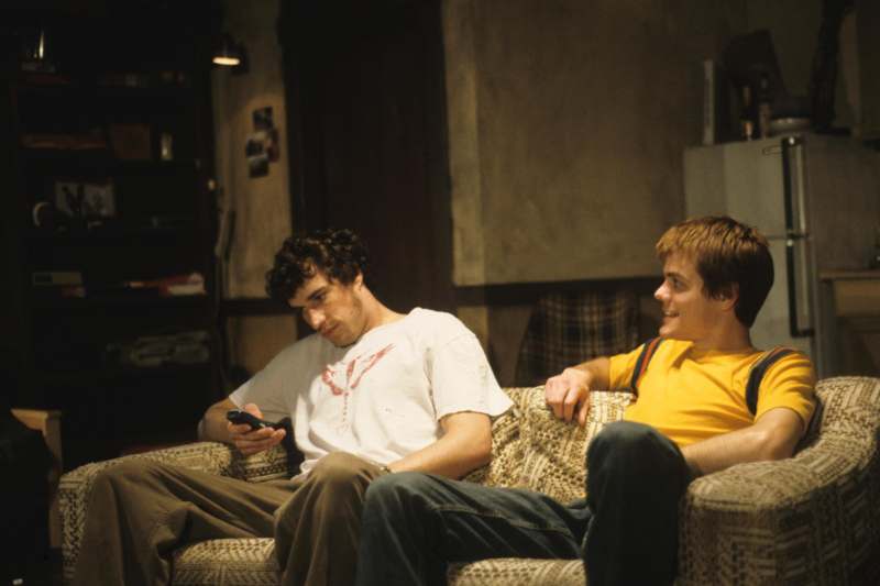 a couple of men sitting on a couch