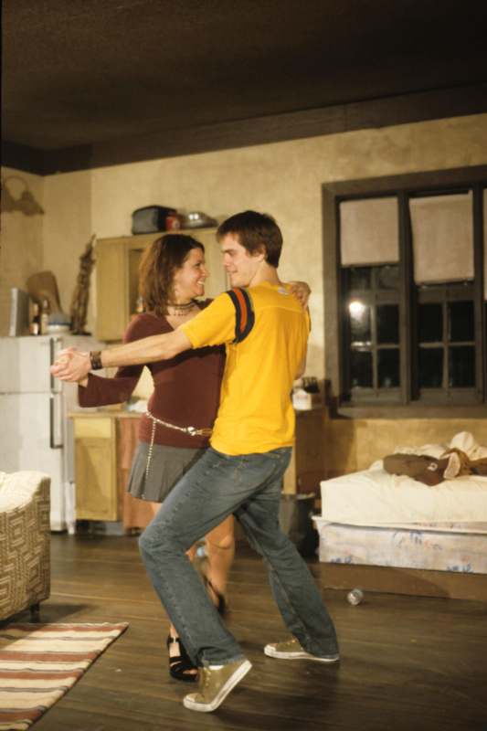 a man and woman dancing in a room