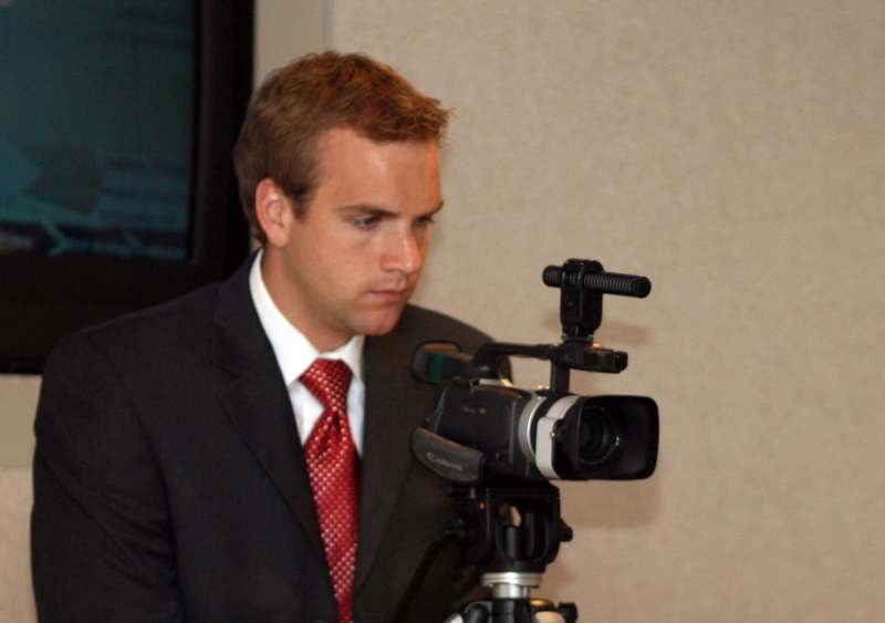 a man in a suit and tie looking at a camera