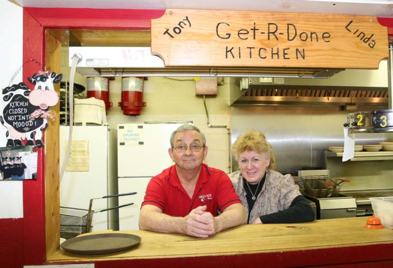 a man and woman sitting at a counter