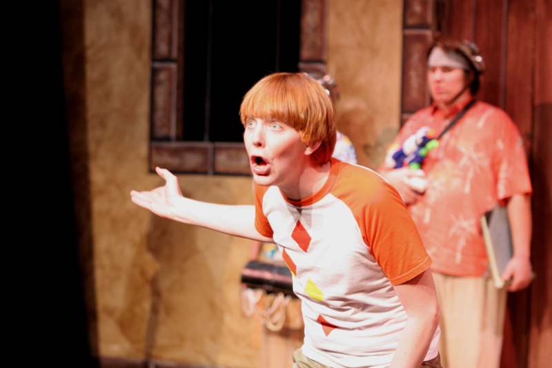 a man with red hair and orange shirt with his mouth open