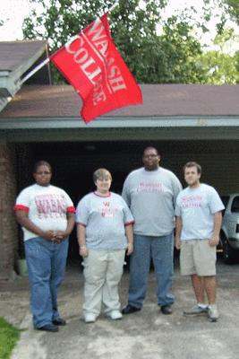 a group of men standing in front of a garage