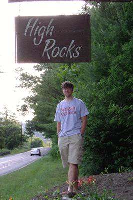 a man standing under a sign