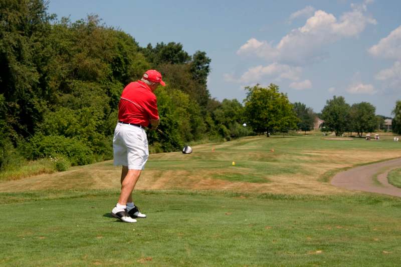 a man playing golf on a golf course