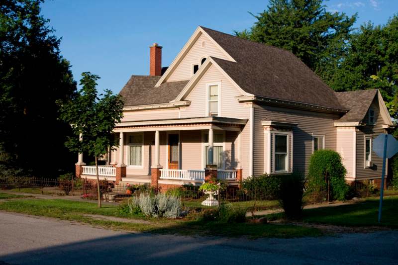 a house with a fence and trees