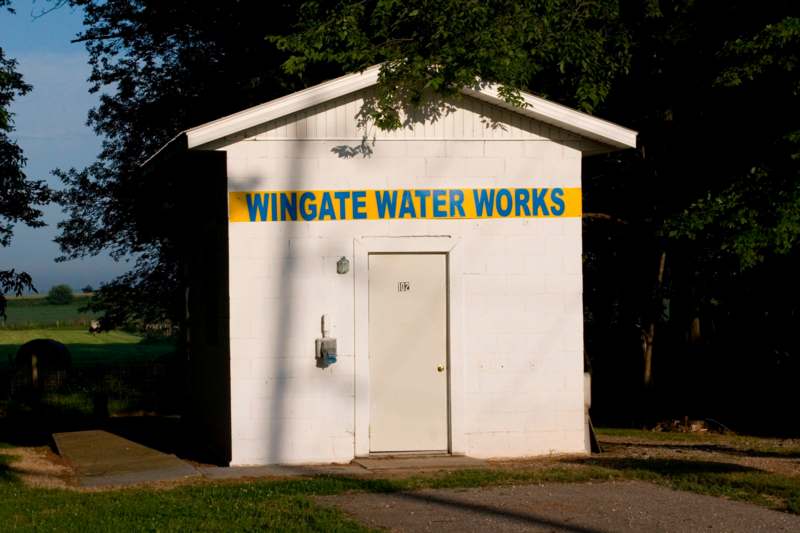a white building with a yellow sign on it