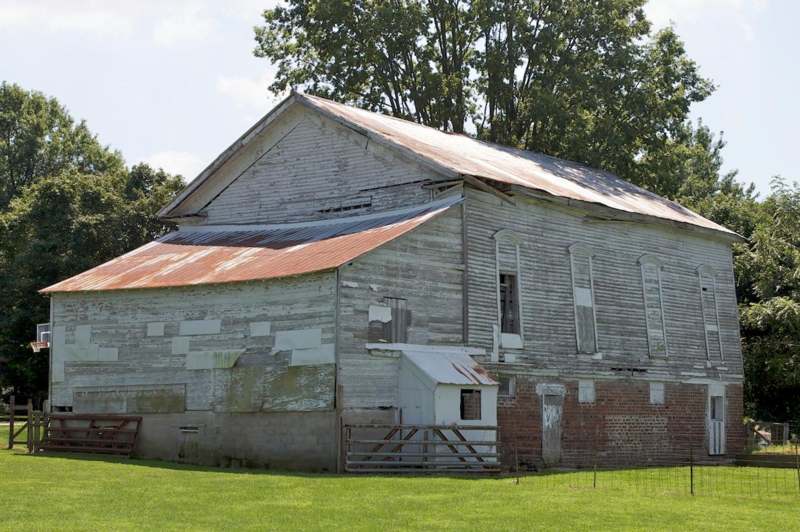 a large old barn with a red roof