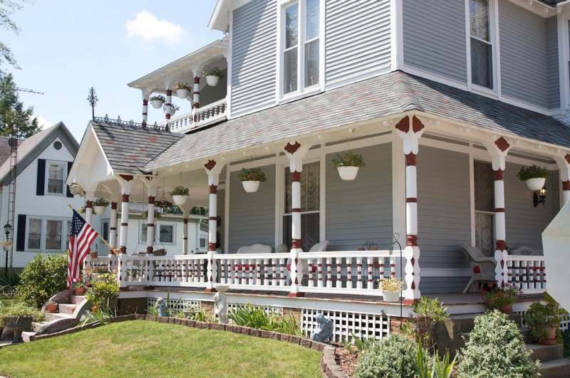 a house with a porch and a lawn