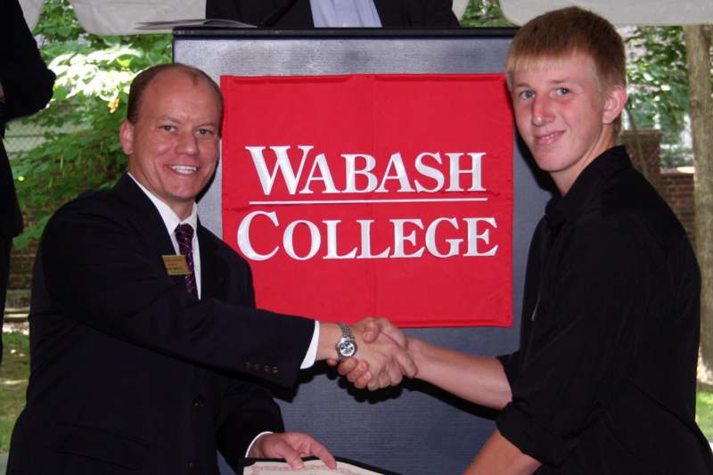 a man shaking hands with another man