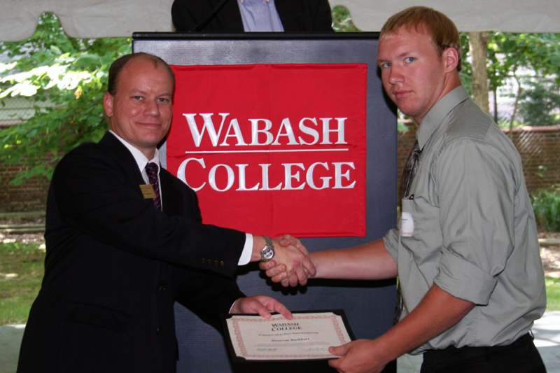 a man shaking hands with another man