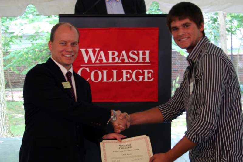 a man shaking hands with another man