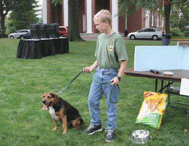 a boy with a dog on a leash