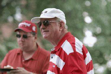 a man wearing a white cap and red shirt