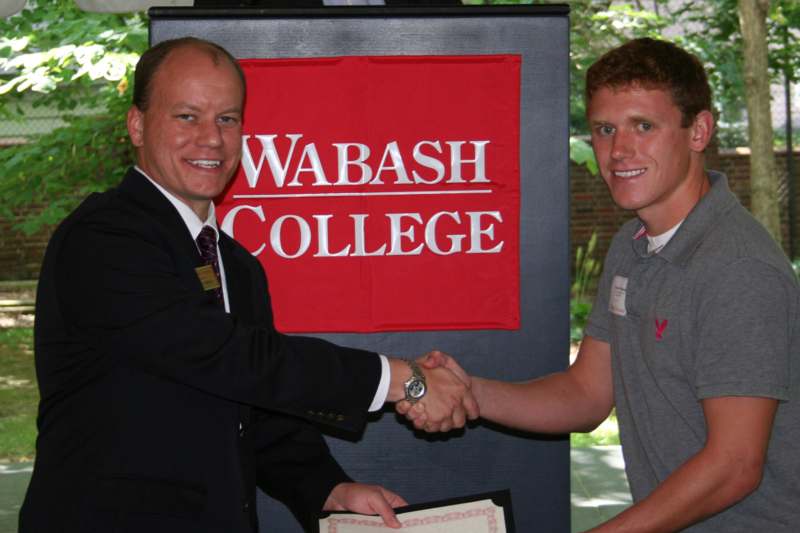 a man shaking hands with another man