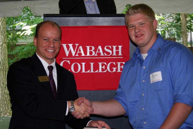 a man shaking hands with another man