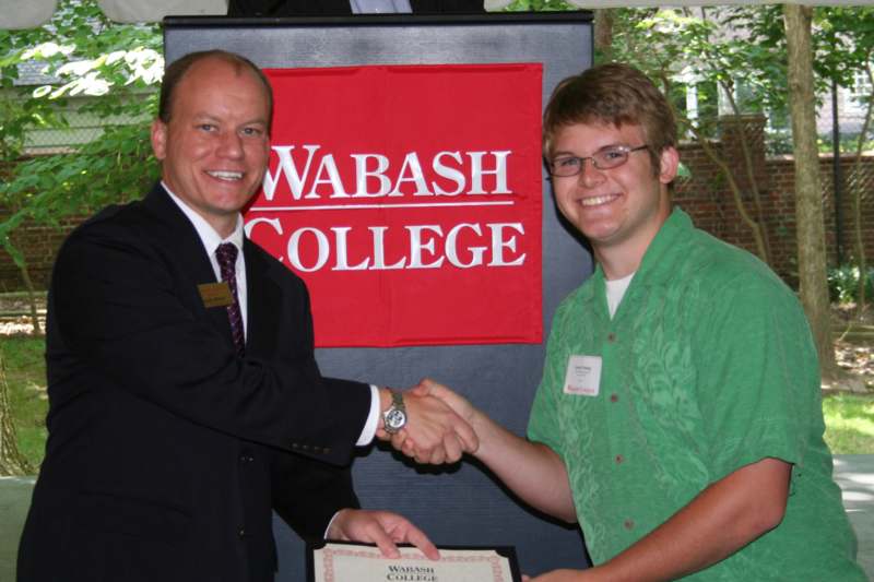 a man shaking hands with another man
