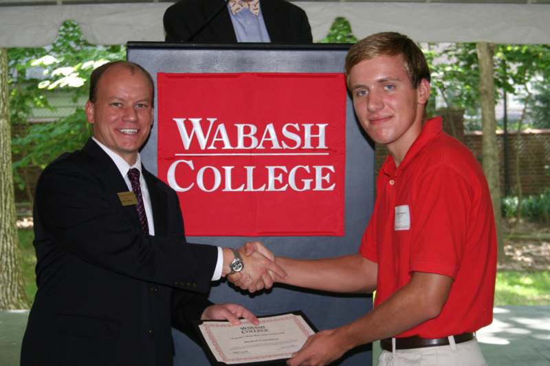 a man shaking hands with another man
